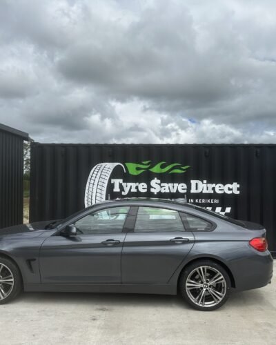 Tyre Save Direct branded container shopfront on SH10, Kerikeri, with a customer car parked outside