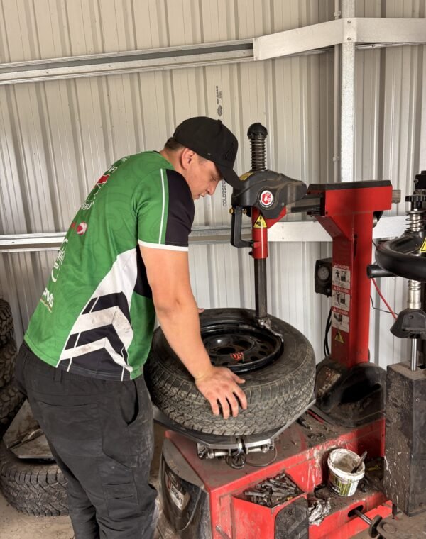 Technician fitting a tyre on the tyre changing machine at Tyre Save Direct, Kerikeri